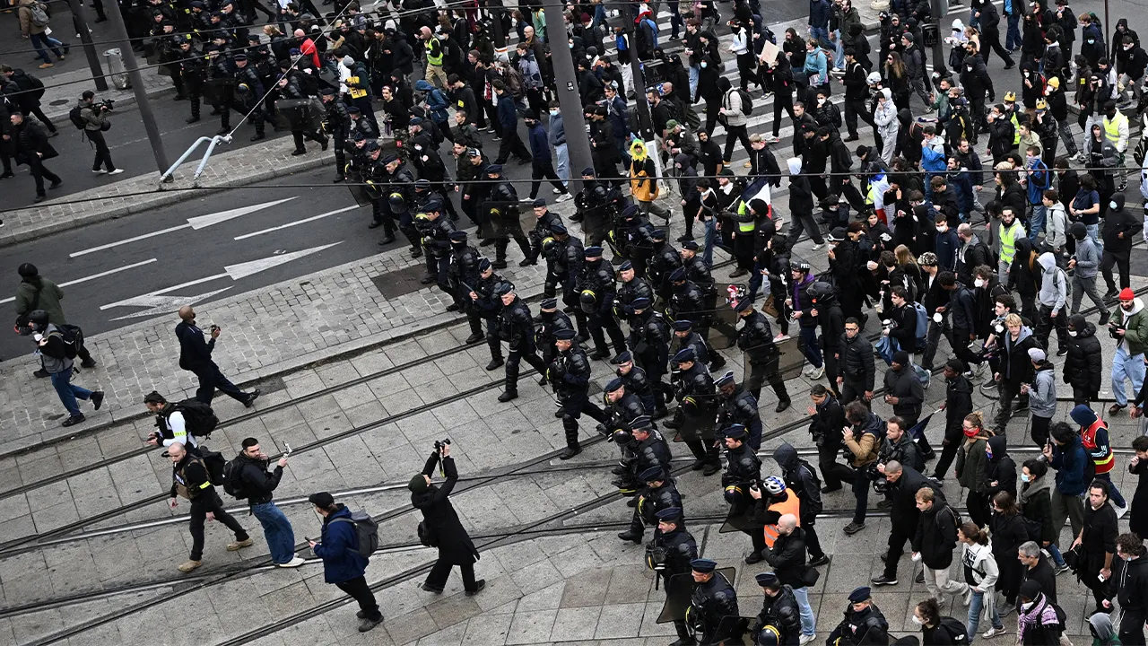 French CRS riot police monitor in front of the march as protesters arrive at the Porte de Vincennes during an authorised demonstration organised by labour unions in Paris as part of nationwide protests called by the "Yellow Vests" movement joined by French high school and university students against the cost of living and rising fuel prices, in France, October 24, 2026. REUTERS/Dylan Martinez