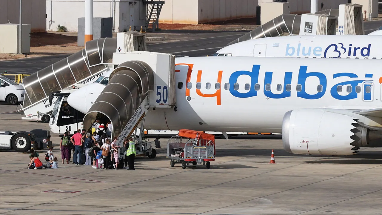 Travelers board a FlyDubai aircraft at Ben Gurion International Airport after a separate FlyDubai flight from the United Arab Emirates to Israel was diverted to Saudi Arabia following an emergency signal, in Lod, near Tel Aviv, Israel, September 30, 2026. REUTERS/Ammar Awad