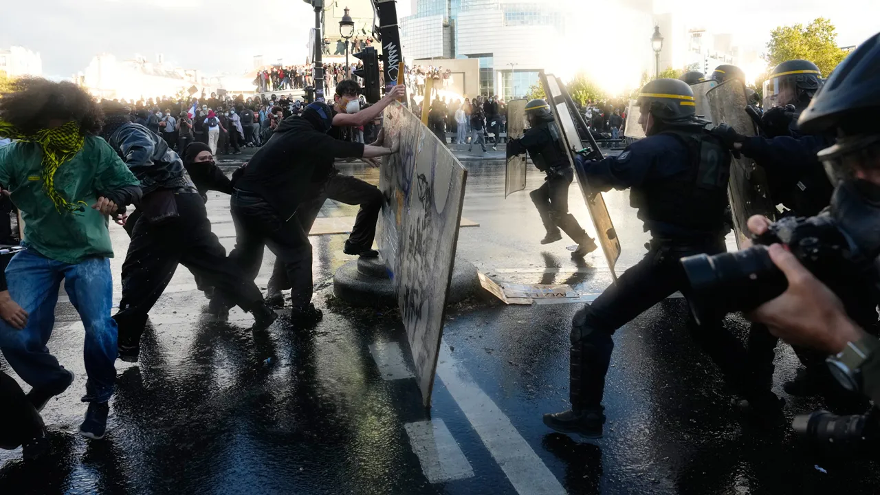 Students scuffle with riot police during a protest against under-resourced schools in Paris, Thursday, Oct. 8, 2026. (AP Photo/Teresa Suarez)