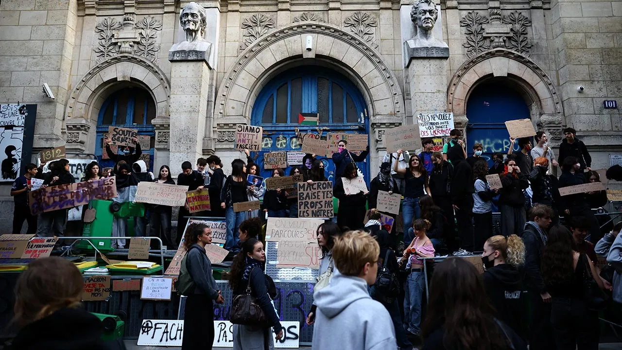 French high school students gather outside the Lycee Voltaire high school as part of nationwide protests to demand the hiring of substitute teachers, increased resources and better learning conditions, in Paris, as more than 400 schools remain closed following days of student protests that have escalated into violence in some places, France, October 2, 2026. REUTERS/Sarah Meyssonnier