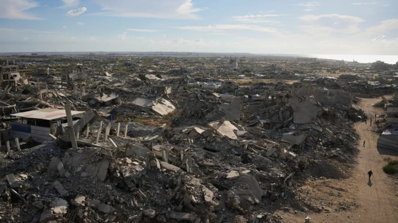 Palestinians walk past buildings destroyed in Gaza City on Tuesday, Oct. 20, 2026. (AP Photo/Abdel Kareem Hana)