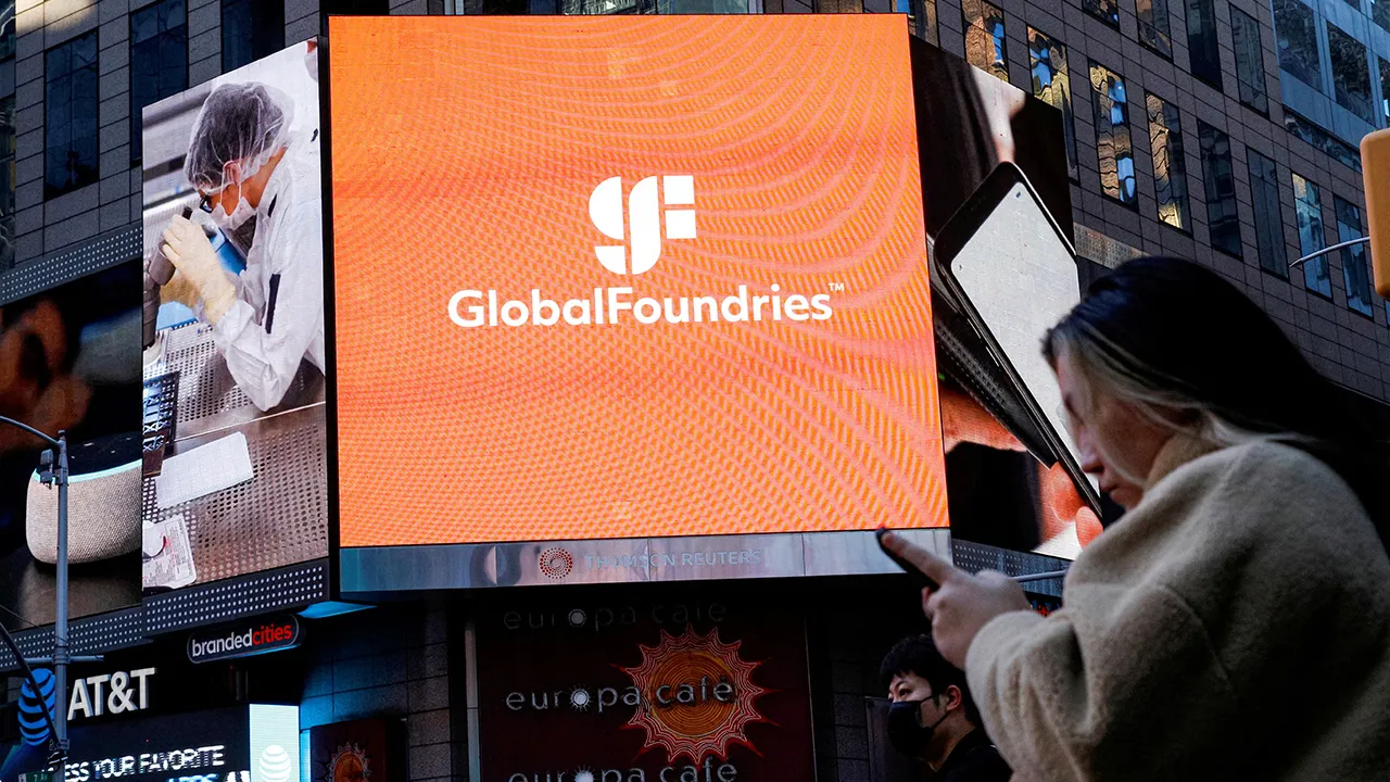 A screen displays the company logo for semiconductor and chipmaker GlobalFoundries Inc. during the company's IPO at the Nasdaq MarketSite in Times Square in New York City, U.S., October 28, 2021. REUTERS
