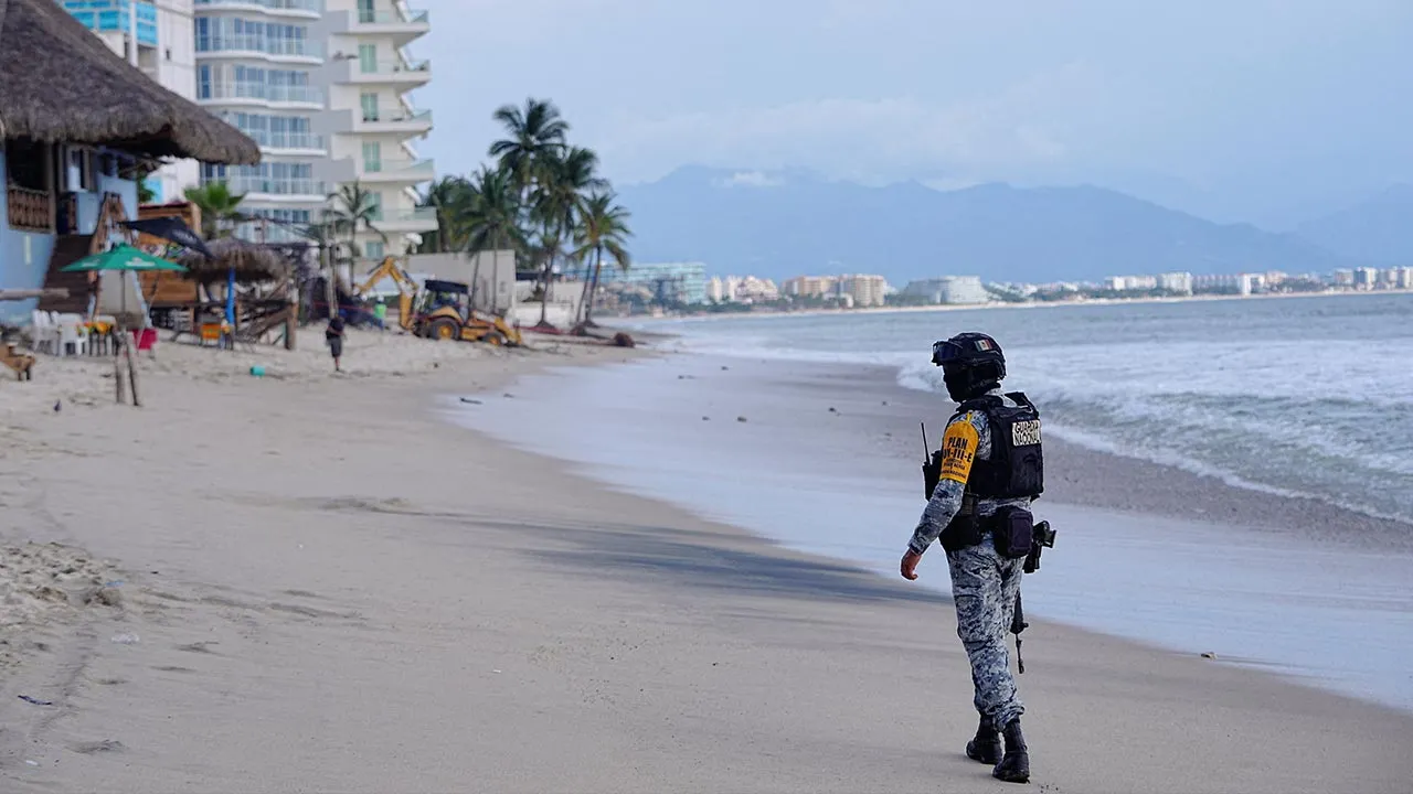 A member of Mexico's National Guard patrols Nuevo Nayarit beach while asking people to leave as residents and businesses prepare for Hurricane Simon in Bahia de Banderas, Nayarit state, Mexico, October 9, 2026. REUTERS/Christian Ruano