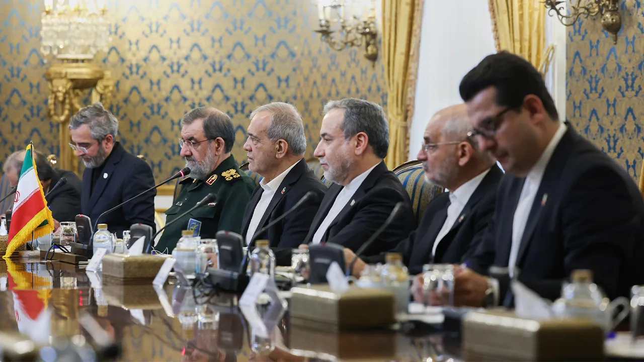 In this photo released by the Iranian Presidency Office, Iran's President Masoud Pezeshkian, third left, attends a meeting with high-level delegations from Saudi Arabia, Pakistan and Turkey, as the secretary of Iran's Supreme National Security Council Mohsen Rezaei, second left, and Foreign Minister Abbas Araghchi, third right, listen in Tehran, Iran, Monday, Oct. 26, 2026. (Iranian Presidency Office via AP)