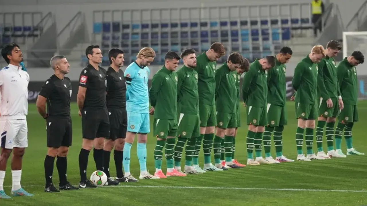 Irish players bow their heads during the Israeli national anthem before the UEFA Nations League match [Darko Vojinovic/AP]