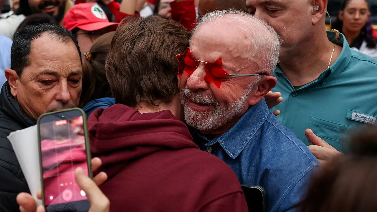 Brazilian President Luiz Inacio Lula da Silva, the Workers' Party (PT) candidate for presidential re-election, embraces a supporter outside his residence on the day of the presidential runoff election, in Sao Paulo, Brazil, October 25, 2026. REUTERS/Tuane Fernandes