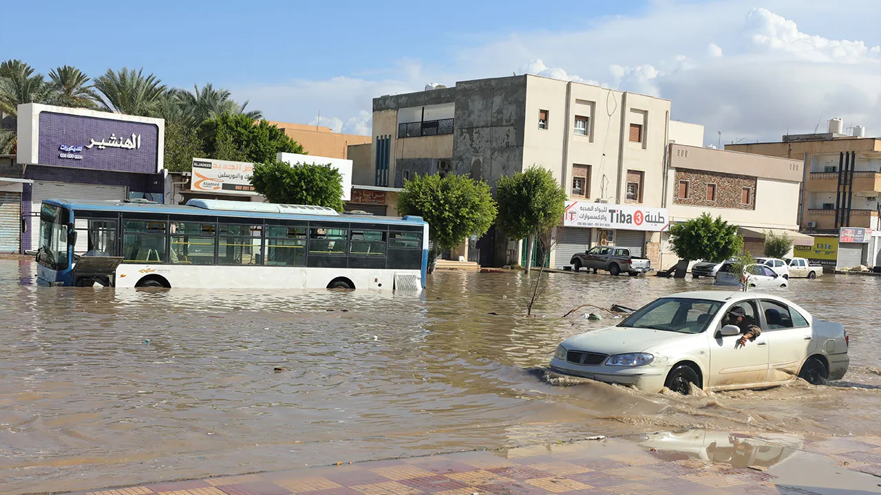Vehicles stranded on a flooded road in Tripoli, Libya, after heavy rains hit the city, Tuesday, Oct. 13, 2026. (AP Photo/Yousef Murad)