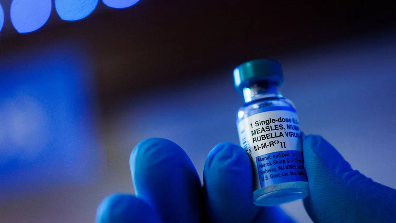 A person poses with a dose of Merck M-M-RII (Measles, Mumps, and Rubella Virus Vaccine Live) in this illustration picture taken in Schwenksville, Pennsylvania, US September 18, 2026. REUTERS/Hannah Beier