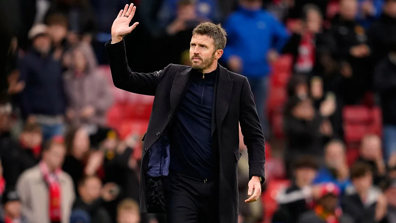 Manchester United's head coach Michael Carrick waves to supporters after his team lost the English Premier League soccer match between Manchester United and Bournemouth in Manchester, England, Sunday, Oct. 25, 2026. (AP Photo/Dave Thompson)