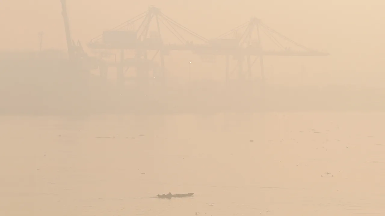 A boat cruises along the Musi River amid thick haze from forest fires in Palembang, South Sumatra, Indonesia, Thursday, Oct. 22, 2026. (AP Photo/Muhammad Hatta)