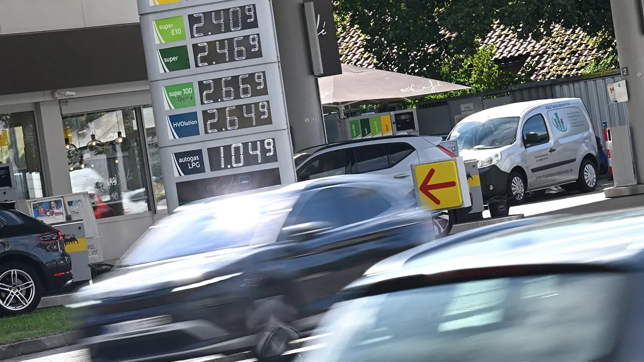 FILE PHOTO: Cars drive past a display board showing the current prices of petrol and diesel at a gas station, in Munich, Germany, September 14, 2026. REUTERS/Angelika Warmuth/File Photo