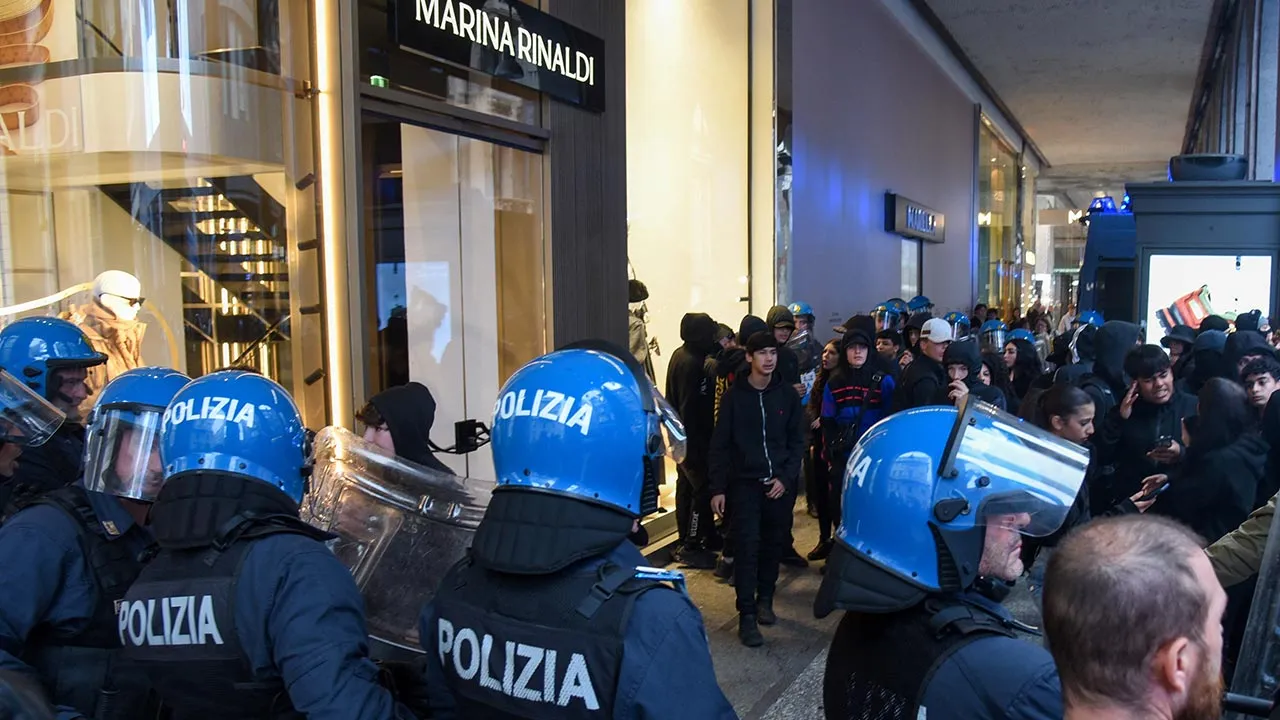 Italian police face a crowd during a protest over the state of public services and the rising cost of living in Milan, Italy, October 18, 2026. REUTERS/Stringer