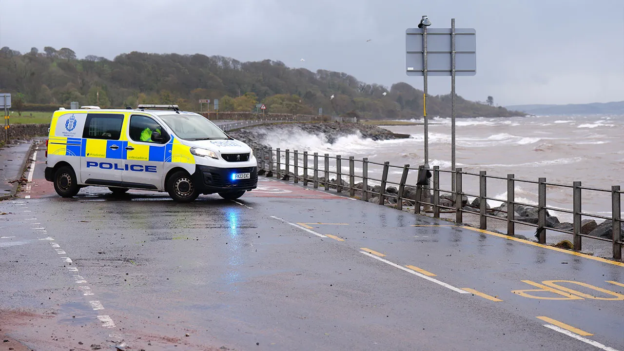 A road is closed by the Police on the A78 near Skelmorlie, Scotland, Sunday, Oct. 25, 2026, after Storm Boelo passed through the area. (Jane Barlow/PA via AP)
