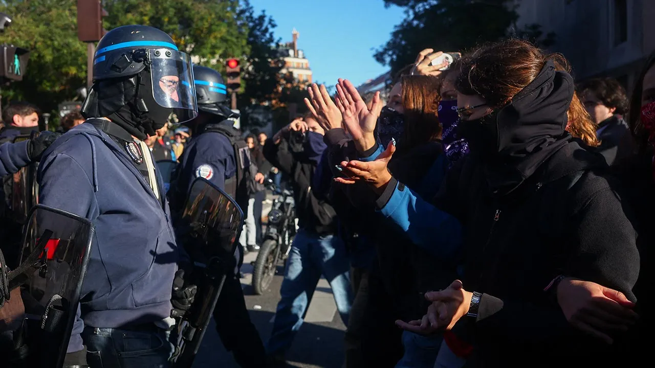 Protesters face French CRS riot police outside Lycee Helene-Boucher high school, during nationwide protests in Paris, France, October 8, 2026, to demand better school conditions. REUTERS/Pedro Nunes