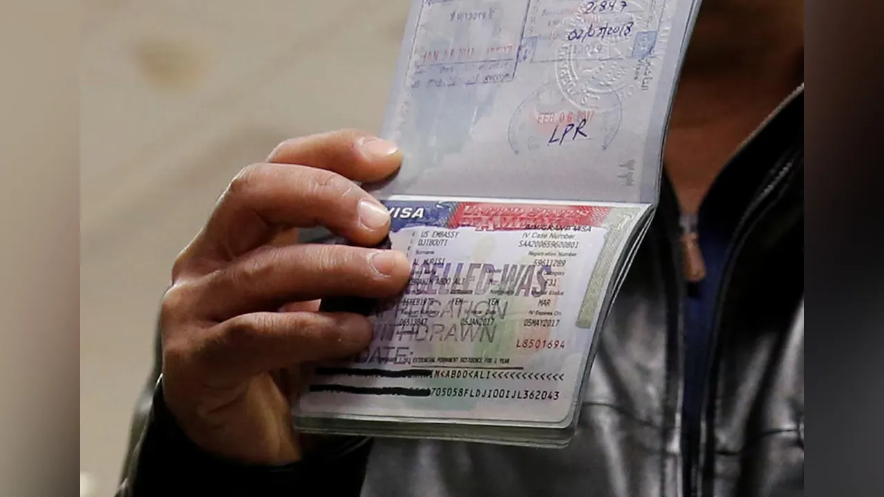 A person shows a cancelled visa in their passport, at Washington Dulles International Airport in Chantilly, Virginia, U.S. February 6, 2017. REUTERS/Jonathan Ernst