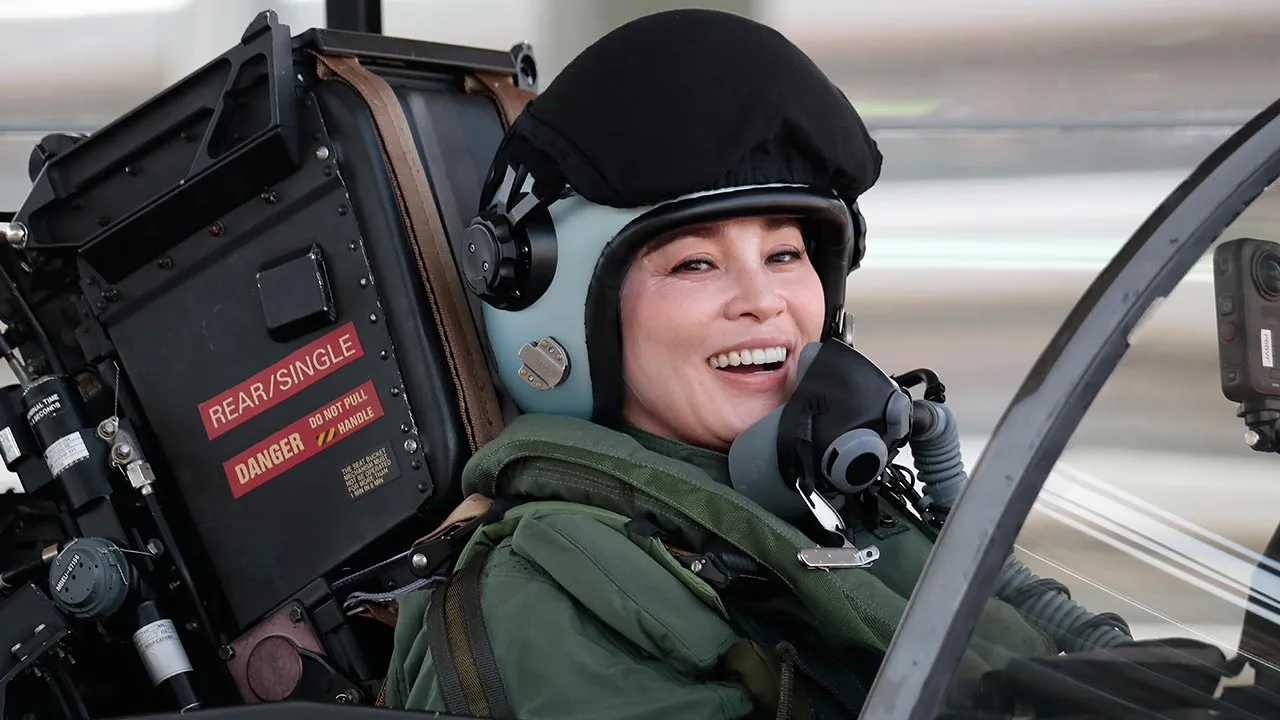 In this photo provided by the Royal Household Bureau, Thailand's Queen Suthida gestures as she made her first solo flight in a Gripen fighter aircraft in Surat Thani, Thailand, Thursday, Oct. 8, 2026. (The Royal Household Bureau via AP)