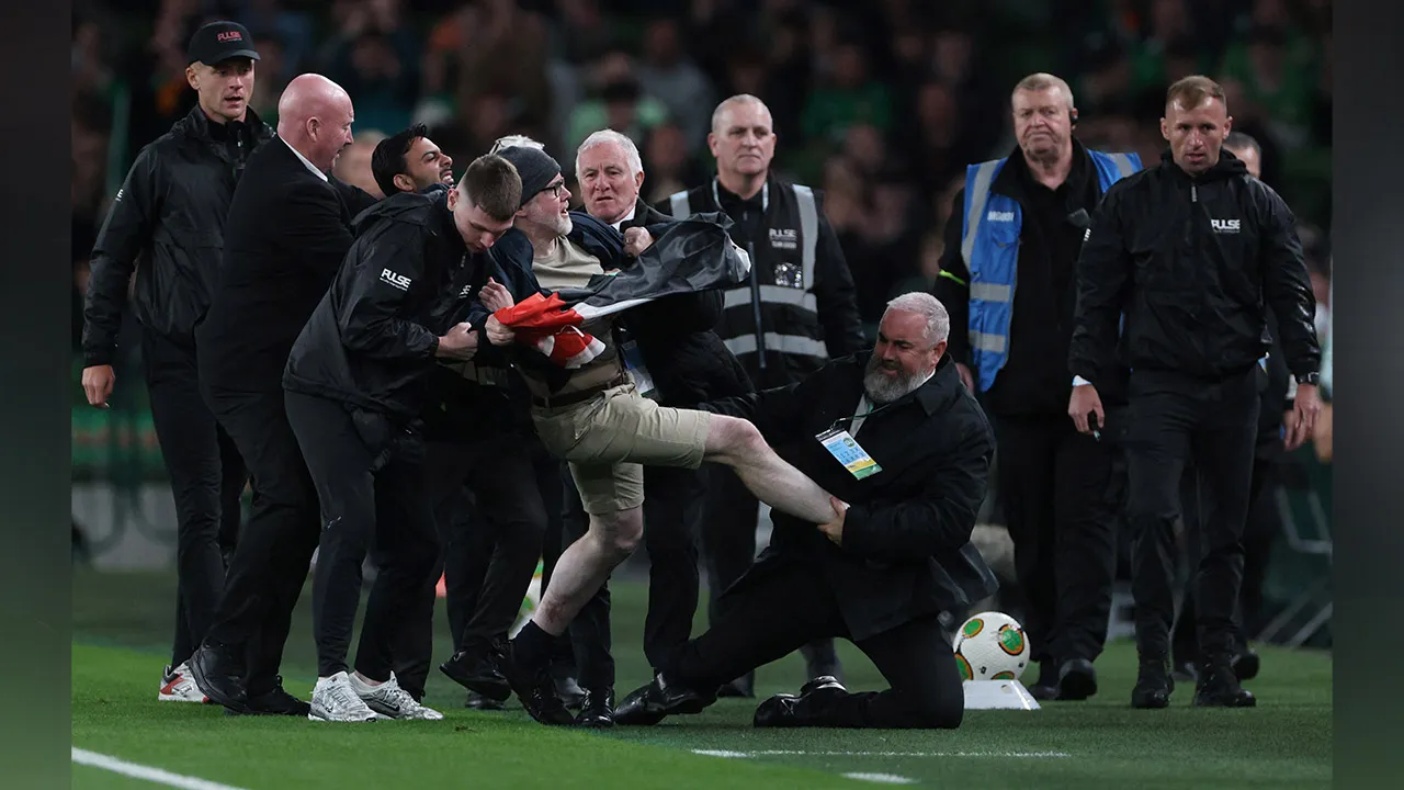 Soccer Football - UEFA Nations League - Group B3 - Republic of Ireland v Austria - Aviva Stadium, Dublin, Ireland - October 1, 2026 A pitch invader is tackled by security during the match REUTERS/Cathal Mcnaughton