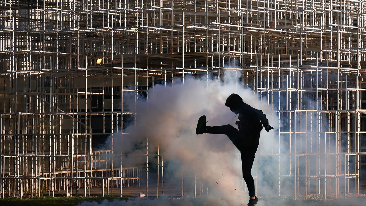 A man reacts as police use tear gas amid an anti-government protest by students in Tirana, Albania, October 14, 2026. REUTERS/Florion Goga