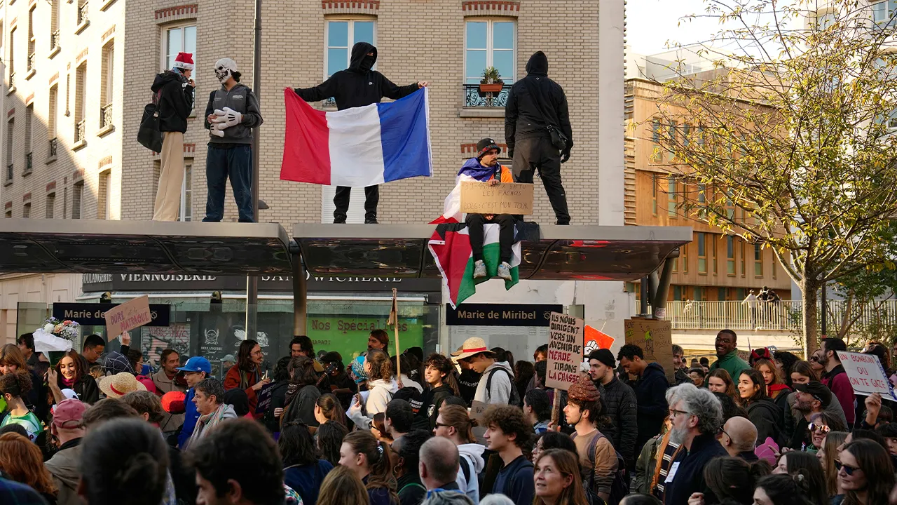 People attend protests over living costs and education in Paris, France, Saturday, Oct. 31, 2026. (AP Photo/Teresa Suarez)